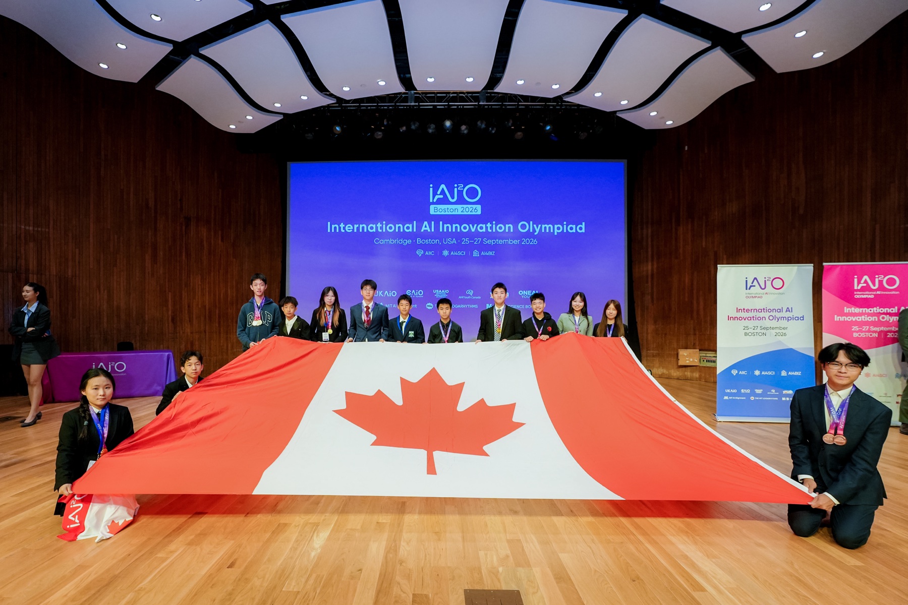 Canadian medalists holding a large Canadian flag at the 2026 IAI2O Global Final